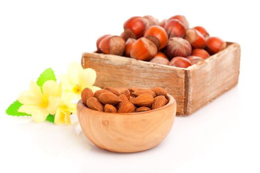 Dried almonds with flowers in the wooden bowl.