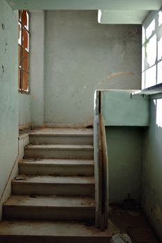 Dirty staircase and peeling walls. Abandoned building interior.