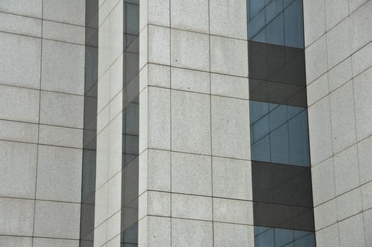 Windows and wall of a modern glass building. Architectural detail.