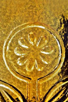 Yellow flower on stained glass and light reflections abstract background.