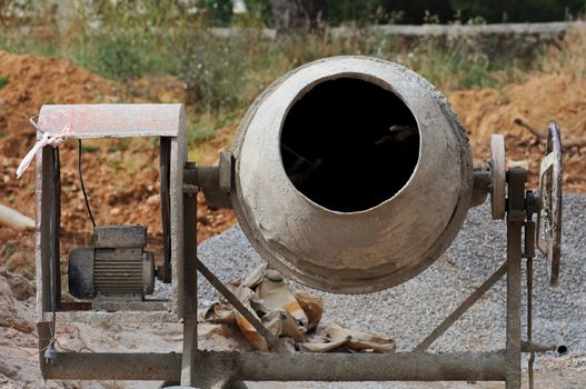 Industrial cement mixer machinery at construction site.