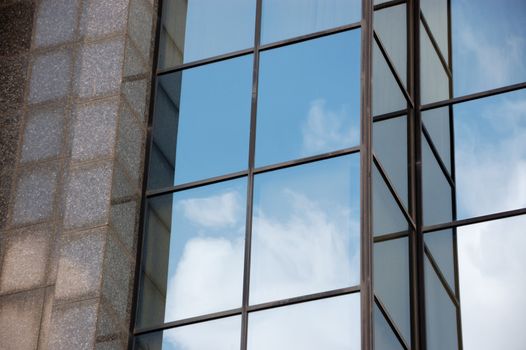 Modern marble and glass facade of high rise building. Architectural background.