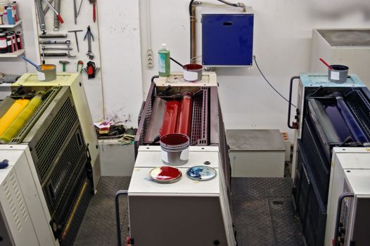 Printing press production line with cmyk colors. Red, blue and yellow ink.