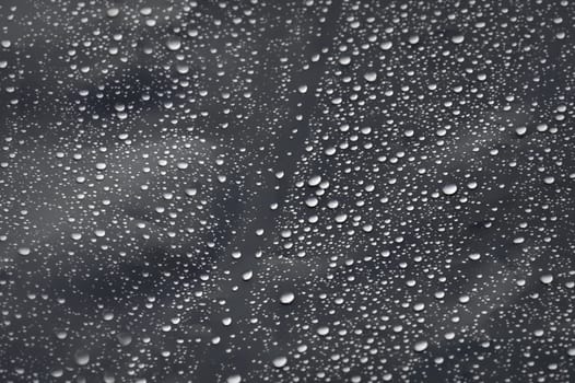 Raindrops on transparent plastic surface. Selective focus.