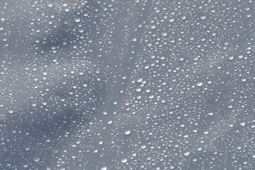 Raindrops on transparent plastic background texture. Selective focus.