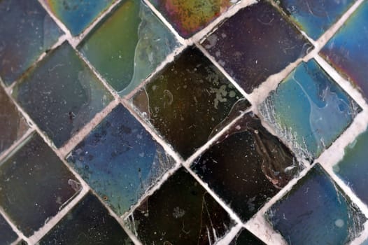 Square pieces of stained glass texture macro. Abstract background selective focus.
