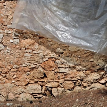 Stone wall and transparent plastic sheet background texture.