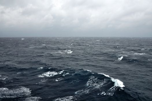 Deep sea water waves and stormy sky.