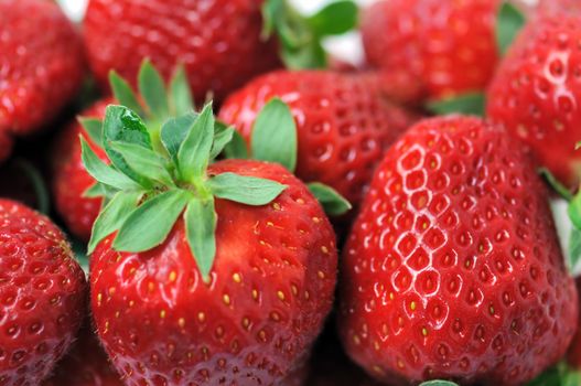 Fresh strawberries with stem background. Selective focus macro.