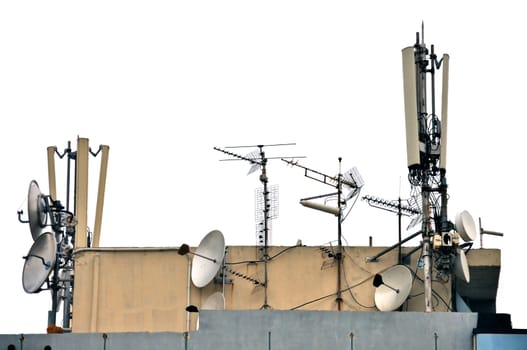Telecommunication antenna and satellite dish receivers on building rooftop. Isolated on white background.