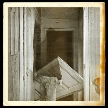 Vintage burned photograph of ghost in haunted hallways of an abandoned house.