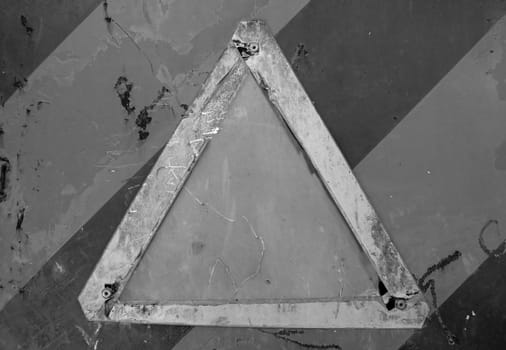Weathered sign on industrial scratched paint rusty metal surface. Black and white.
