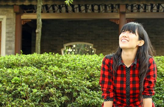 Chinese girl smiling in a garden
