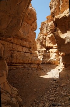 Narrow slot between two rocks in desert canyon