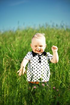 little boy play in green grass