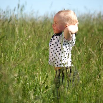 little boy play in green grass