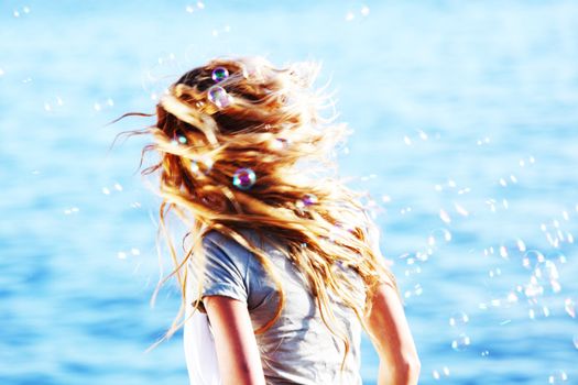 happy blond hair woman sea on background