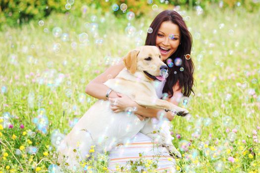 woman and she lablador dog in green grass