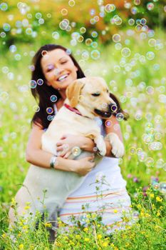 woman and she lablador dog in green grass