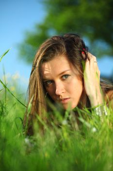 happy woman lay on green grass under tree