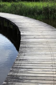 A wooden path in wetland park