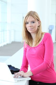 young woman typing on her laptop