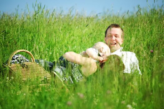  happy family on picnic in green grass