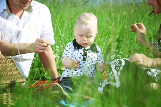  happy family on picnic in green grass