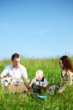  happy family on picnic in green grass