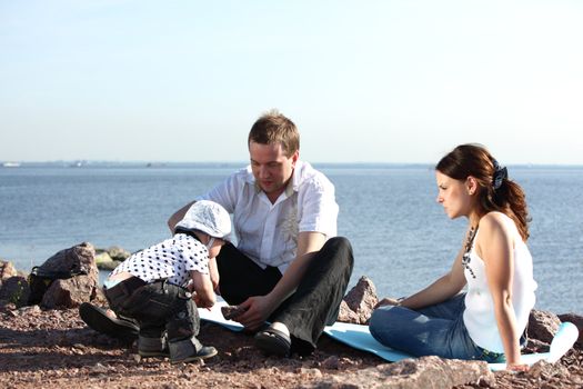 happy family on picnic sea on background