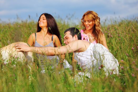 friends and dog in green grass field