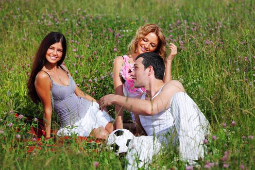 friends and dog in green grass field