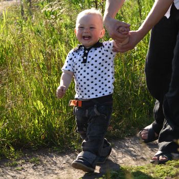 father and son walking on grass