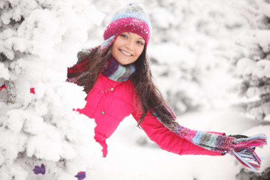 winter girl behind snow tree 