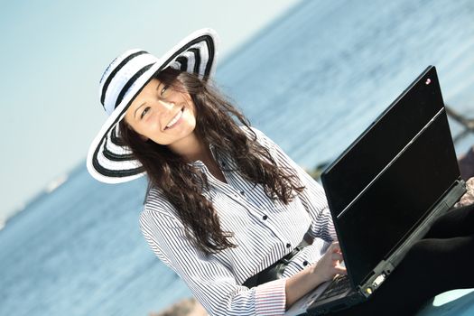 woman with laptop sea background