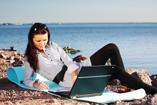 woman with laptop sea background