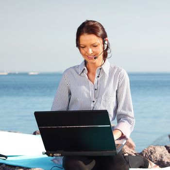 woman with laptop sea background