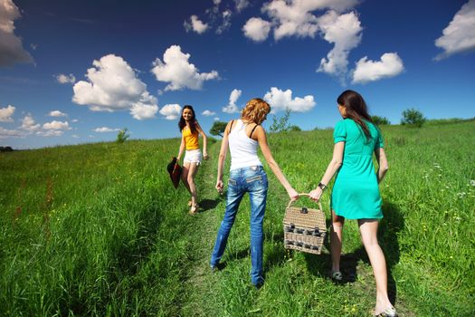 girlfriends on picnic in green grass field