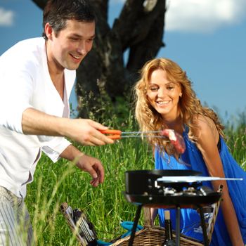 man and woman on picnic in green grass