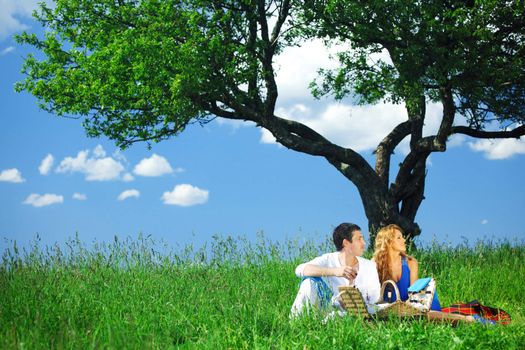 man and woman on picnic in green grass