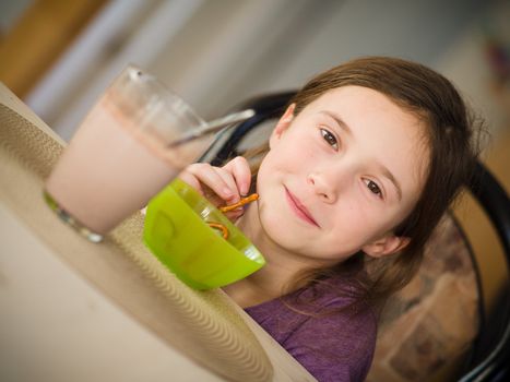 Girl having a hot chocolate and a snack