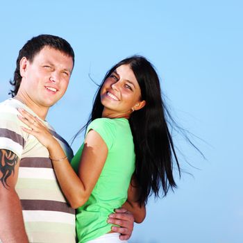 man and woman hug in the sky sea on background