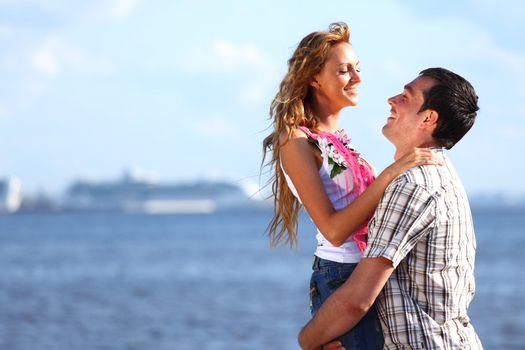 man and woman hug in the sky and sea on sea