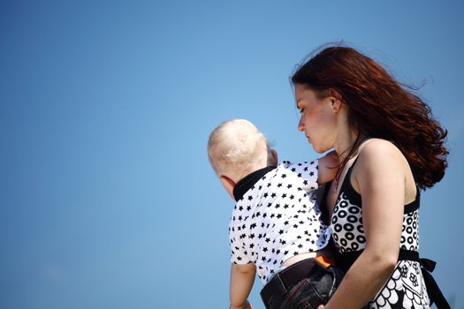 happy mother and son in blue sky