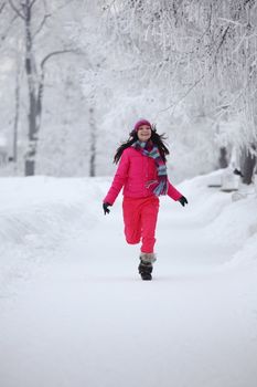 woman run in winter park very happy