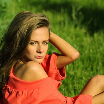 young sommer woman on green grass