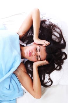 waking woman on the white pillow