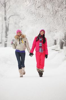 two winter women run by snow frosted alley