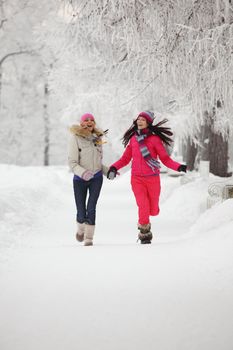 two winter women run by snow frosted alley