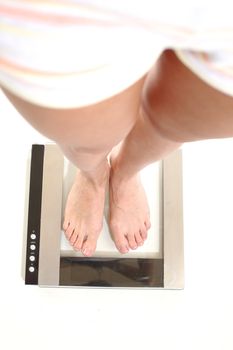 legs on scales isolated on white background